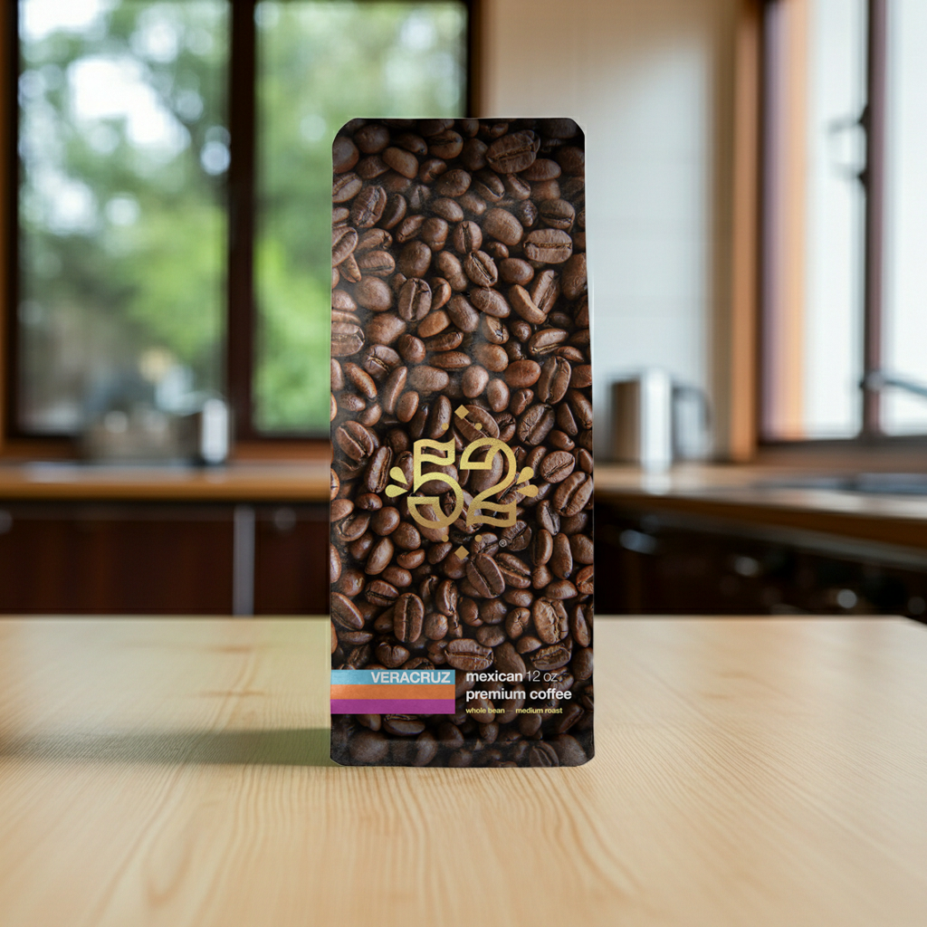 Coffee bean packaging with '52' logo on a wooden table in a kitchen setting