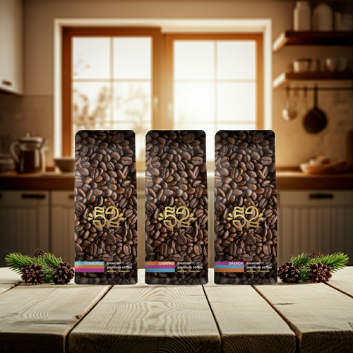 Three packages of coffee beans on a wooden table with a kitchen background